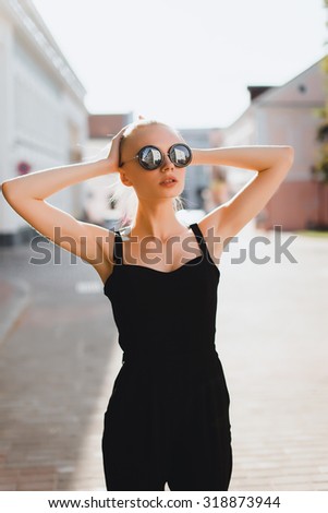 Amazing young beautiful girl posing outdoors at sunny day . Lifestyle urban mood. Center city background.wearing black casual fall outfit.Autumn clothes,trendy outfit,fashionable,trendy
