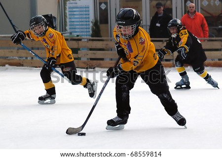 BELGRADE-JANUARY 8:Unidentified ice hockey players in action with puck at New Year\'s ice hockey tournament for children aged eight years on January 8, 2011 in BELGRADE,SERBIA