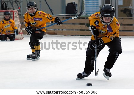 BELGRADE-JANUARY 8:Unidentified two ice hockey players in action with puck at New Year's ice hockey tournament for children aged eight years on January 8, 2011 in BELGRADE,SERBIA