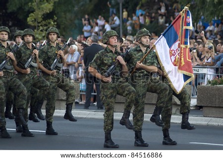 BELGRADE, SERBIA - SEPTEMBER 10: Soldiers with Serbian national flag march during promotion of new Serbian army officers on September 10, 2011 in Belgrade, Serbia