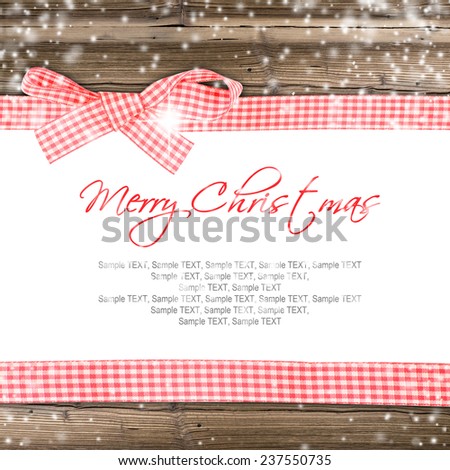 Grunge wooden texture with red ribbon and snow flakes and white space, horizontal composition