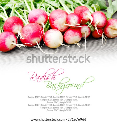 Photo of radish with leaves on wooden board with white space