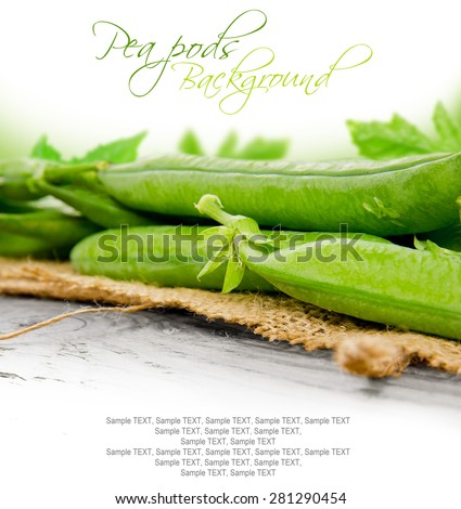Photo of pods with peas on wooden board with white space