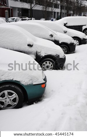 Cars under snow. Parked cars under snow.