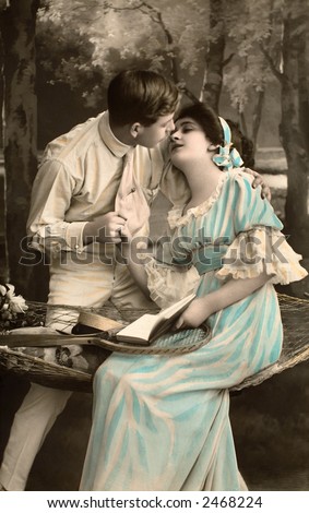 Victorian romance - couple in love on swing - circa 1916 hand-tinted photograph