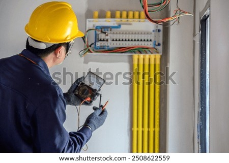 Similar – Image, Stock Photo Electrician working on the distribution panel of a house