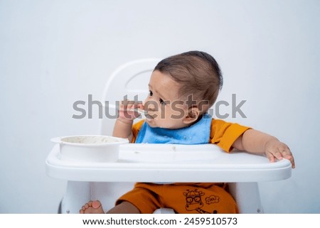 Similar – Image, Stock Photo 6 month old baby playing wearing black and white playing with colorful ring stack toy