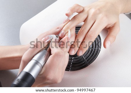 Manicure. The device removes the cuticle