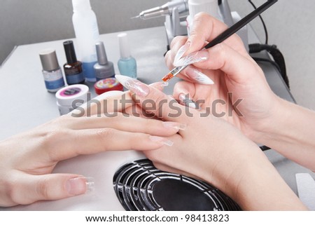 Manicure. Master make nail extension: drawing of the second layer of gel