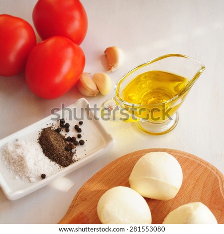 Marinara sauce with olive oil, cheese, tomatoes on white background