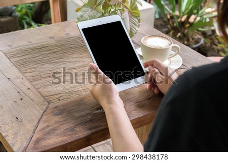 woman work on your  laptop and drinking coffee in cafe