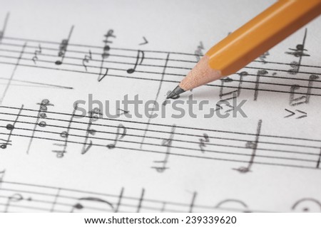 Music notes and pencil, shallow DOF
