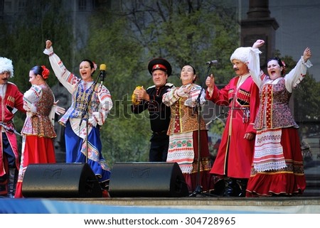 Orel, Russia, August 4, 2015: Orlovskaya Mozaika folk festival, men and women in traditional Cossack suits dancing in the scene