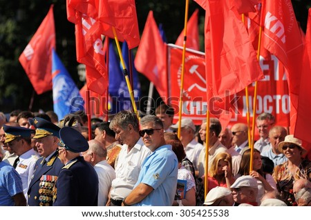 Orel, Russia - August 5, 2015: war veterans with medals and communist red flags