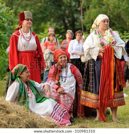 Orel, Russia - June 19, 2015: Orlovskaya Mozaika music fest: girls and women in traditional Russian dress standing and sitting in hay