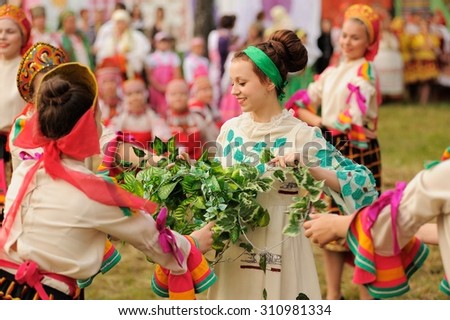 Orel, Russia - June 19, 2015: Orlovskaya Mozaika music fest: girls in traditional Russian dress dancing with birch branches