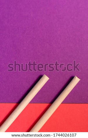 Similar – Image, Stock Photo Two cigarettes from above laying flat on pink and purple backgrounds as a symbol of female smoking