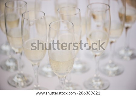 Portrait of a waiter pouring champagne into a flute