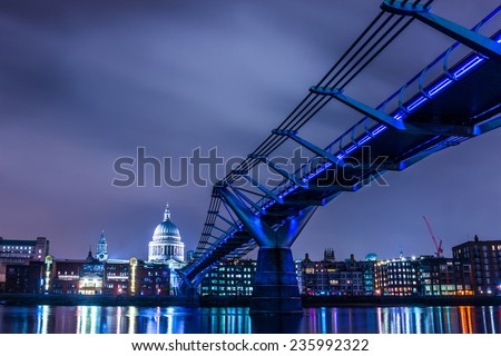 Millennium Bridge leads to Saint Paul\'s Cathedral in central London at night, cross processing