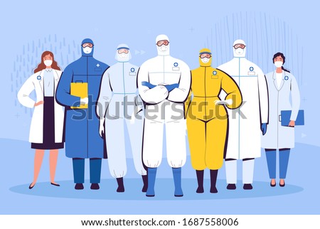 A group of doctors in protective suits, glasses and medical masks are standing next to each other. The concept of the struggle of medical personnel with the new coronavirus COVID-2019