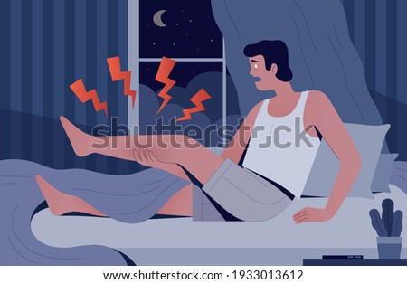 The man woke up in the night from severe pain. A man has a cramp in his own bed. The concept of sudden pain in the middle of the night