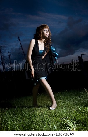 Young Girl Brightly Lit in front of Night sky