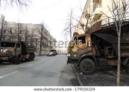 KIEV, UKRAINE - FEB 26, 2014: Burned car covered with flowers in memory of protesters killed in February 19.