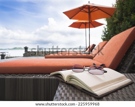 Beach chair Summer holiday vacation with book and eyeglasses