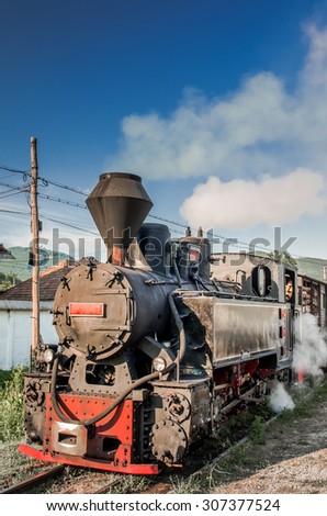 Old black steam powered railway train. Restored old vintage steam train built at Resita, Romania.