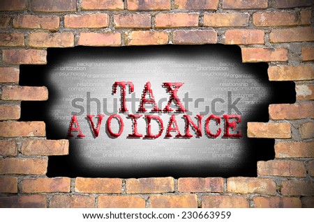 Business Concept - Hole At The Brick Wall And Found Caption Tax Avoidance Inside The Wall.