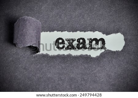 exam word under torn black sugar paper