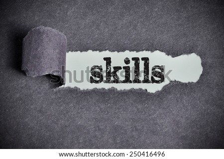 skills word under torn black sugar paper