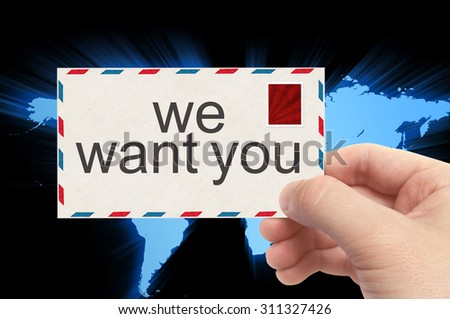 hand holding envelope with we want you word on world background.