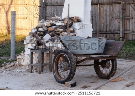 Similar – Image, Stock Photo An old rusty wheelbarrow with a fat black balloon tyre tries to hide in a lilac bush, but doesn’t quite succeed