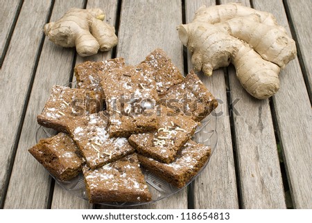 homemade ginger cookies over wooden table with fresh ginger root