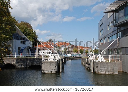 Contrast between modern and antique buildings on different sides of the lock in the Netherlands