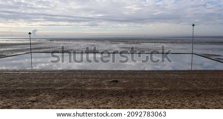 Southend on Sea, Essex, United Kingdom, November 23, 2021. Simple minimalist monochrome view over children's paddling pool lido to river Thames estuary. Outdoors on a bright sunny autumn winter day Foto stock © 