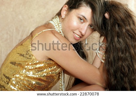 pretty girl in gold dress with long hair