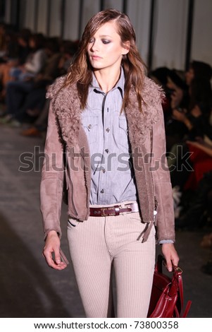 NEW YORK - FEBRUARY 15: Top model Karmen Pedaru walks the wooden runway at the DIESEL BLACK GOLD Fall 2011 Collection presentation during Mercedes-Benz Fashion Week on February 15, 2011 in New York.