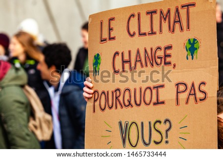 French sign at environmental protest. A French poster is viewed close-up, saying the climate is changing, why not you, as during an ecological activism march on a street in Montreal, Canada Photo stock © 