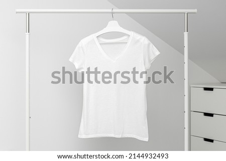V neck t-shirt hanging on Clothing rack. White color. Template, mock up Сток-фото © 