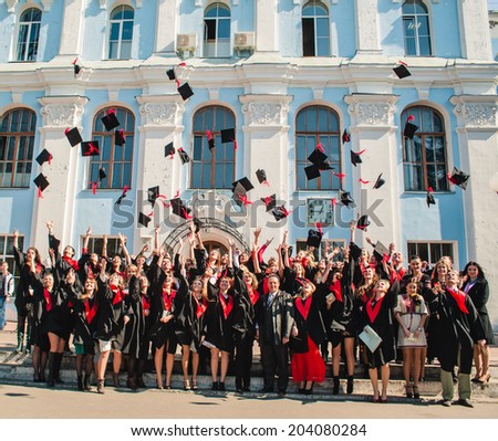 Kiev, Ukraine - March 28: Students in mantle throwing academic caps near the National University of Biotechnology March 28, 2014 in Kiev, Ukraine