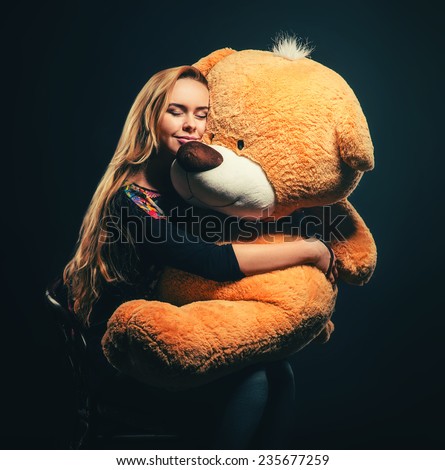 beautiful young woman with big teddy bear