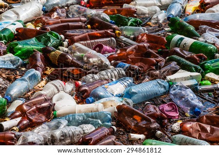 CARPATHIANS, UKRAINE - MAY 03, 2015: plastic bottles and trash in the river water
