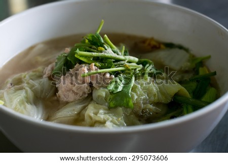 clear soup with pork in white plate put on table, Thai cuisine.