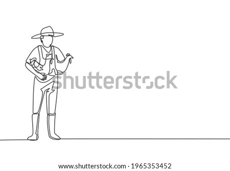 Single one line drawing of young male farmer carried the chicken with both hands to return to the coop. Farming challenge minimal concept. Continuous line draw design graphic vector illustration.