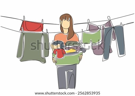 Single continuous line drawing a woman holding a basket filled with piles of clothes. Lift clothes that are dry and clean. Housework. National Hanging Out Day. One line design vector illustration