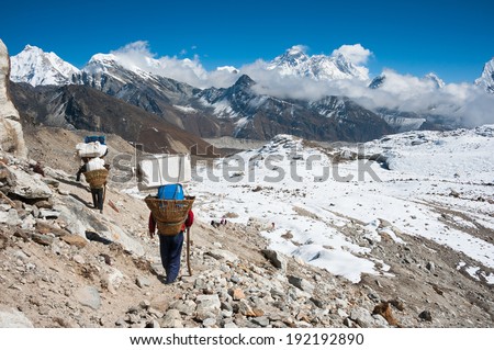 Porter, with Mt. Everest and the himalayas from Renjo mountain pass, Nepal
