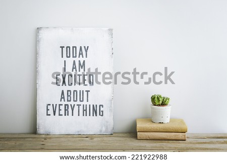 motivational inspirational poster quote TODAY I\'M EXCITED ABOUT EVERYTHING on the white wall. American or Scandinavian style room interior.