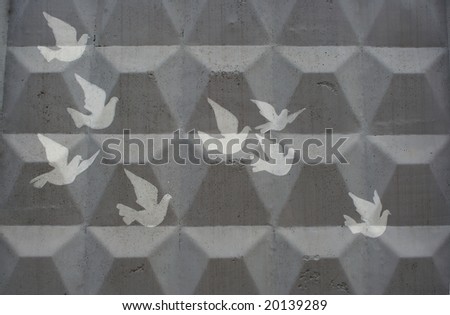 cliche drawing of doves on a grey concrete wall